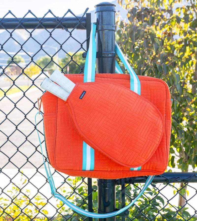 Load image into Gallery viewer, Jacquard Terry Pickleball Tote Tangerine On fence
